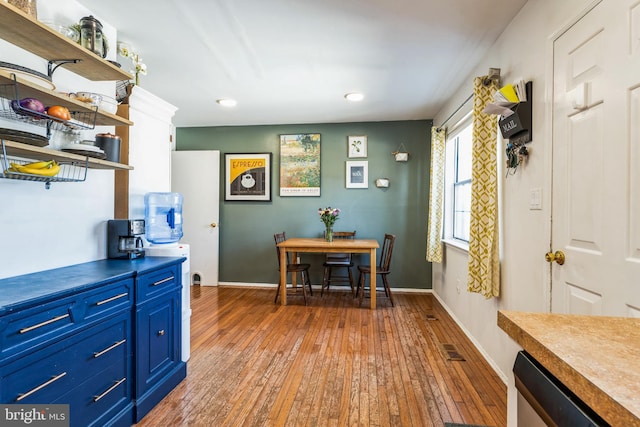 dining space with visible vents, baseboards, and light wood finished floors