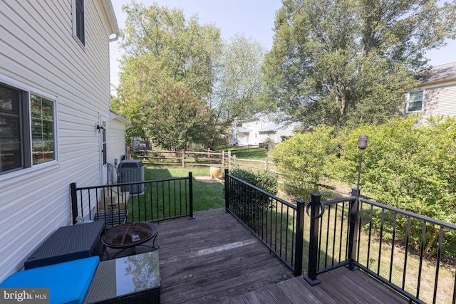 wooden deck featuring a fire pit and fence