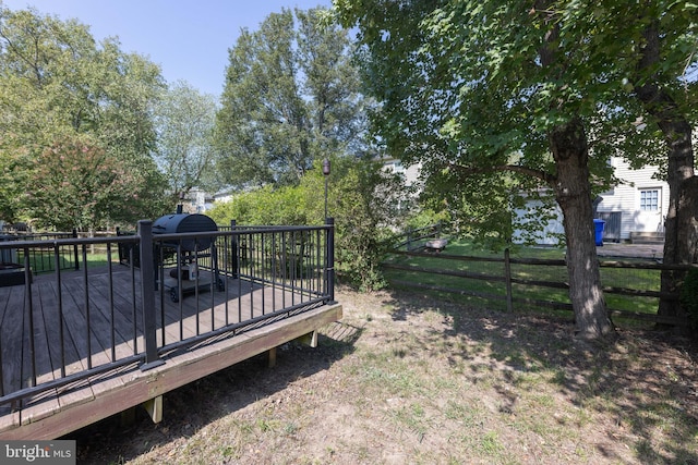 view of yard featuring a wooden deck and fence