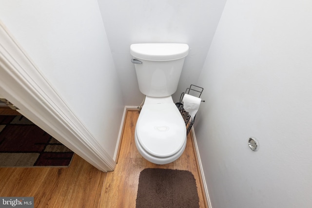 bathroom featuring baseboards, toilet, and wood finished floors