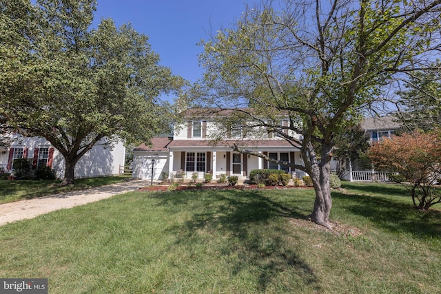 view of front of home with driveway, an attached garage, and a front yard