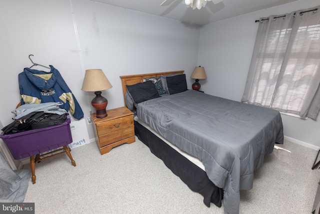 carpeted bedroom with a ceiling fan and baseboards