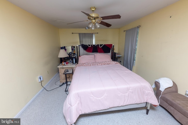 carpeted bedroom featuring ceiling fan and baseboards