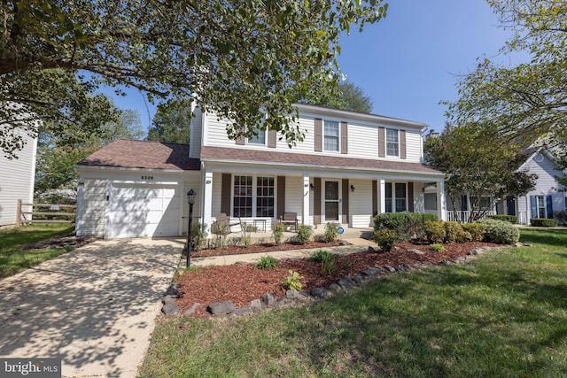 traditional-style home with a front yard, fence, driveway, an attached garage, and covered porch