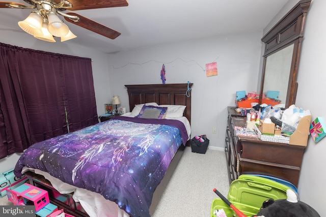 carpeted bedroom featuring baseboards and a ceiling fan