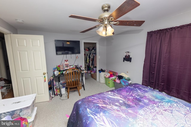 bedroom featuring a closet, a spacious closet, and a ceiling fan