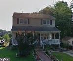 view of front of property featuring a vegetable garden and a front lawn