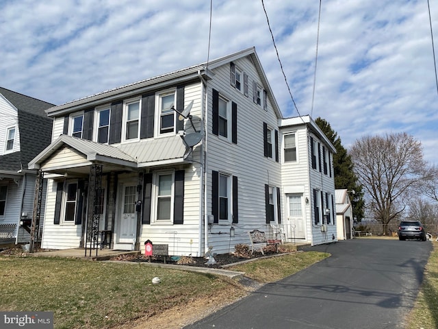 view of front of home with a porch and metal roof