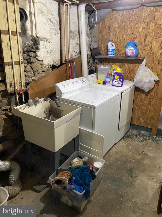 laundry room with a sink, laundry area, and washing machine and clothes dryer