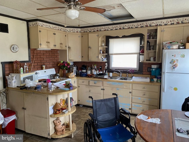 kitchen with a ceiling fan, open shelves, a sink, white appliances, and a paneled ceiling