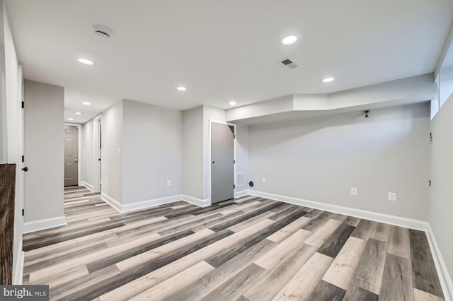 finished basement with wood finished floors, recessed lighting, and baseboards