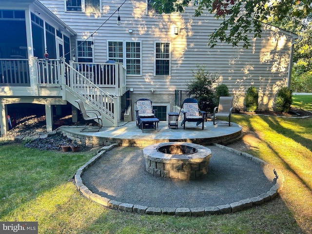 view of patio / terrace with a fire pit, stairs, and a deck