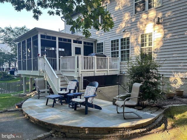 view of patio / terrace with stairs and a sunroom