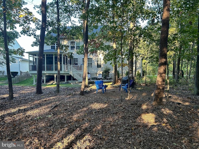 back of house with fence, stairs, and a sunroom