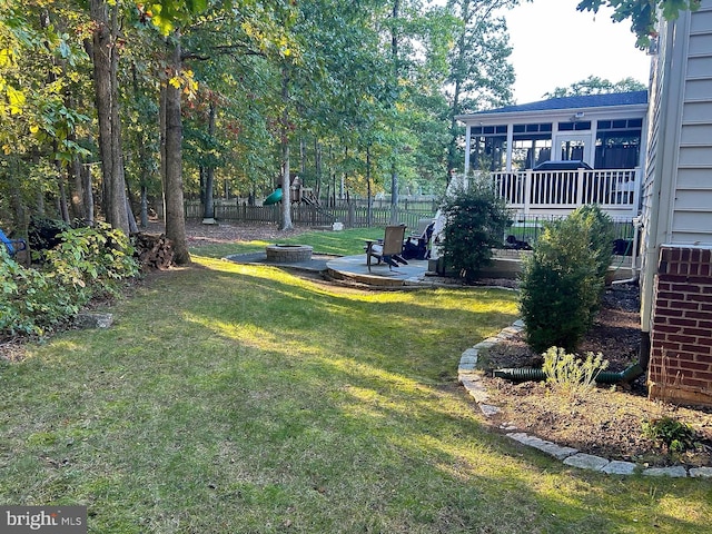 view of yard featuring a playground, a patio, and fence