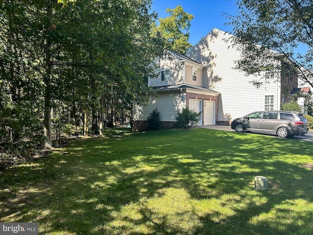 view of home's exterior featuring a lawn and a garage