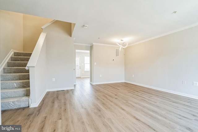 unfurnished living room featuring stairway, visible vents, baseboards, light wood finished floors, and ornamental molding