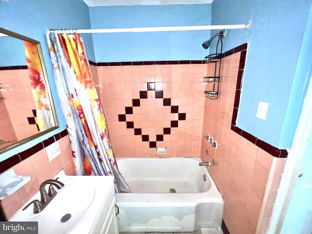 bathroom featuring vanity, tile walls, and shower / bath combo with shower curtain