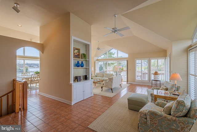 living room with built in shelves, light tile patterned floors, and a wealth of natural light