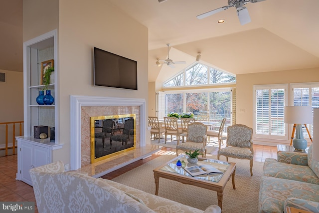 living area featuring light tile patterned floors, a fireplace, visible vents, and a wealth of natural light