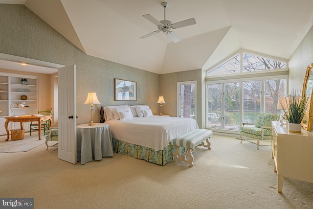 carpeted bedroom with wallpapered walls, ceiling fan, and high vaulted ceiling