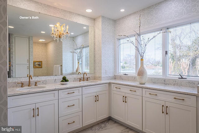 full bathroom featuring double vanity, recessed lighting, marble finish floor, and a sink