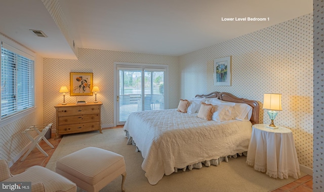 bedroom featuring wallpapered walls, access to outside, baseboards, and visible vents