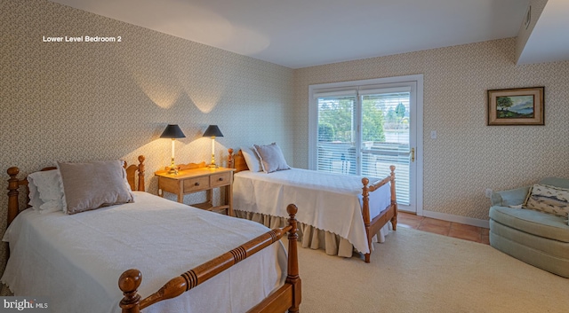 bedroom featuring tile patterned floors, baseboards, access to exterior, and wallpapered walls