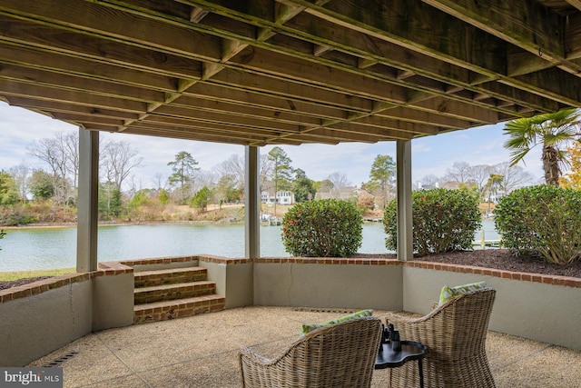 view of patio with a water view