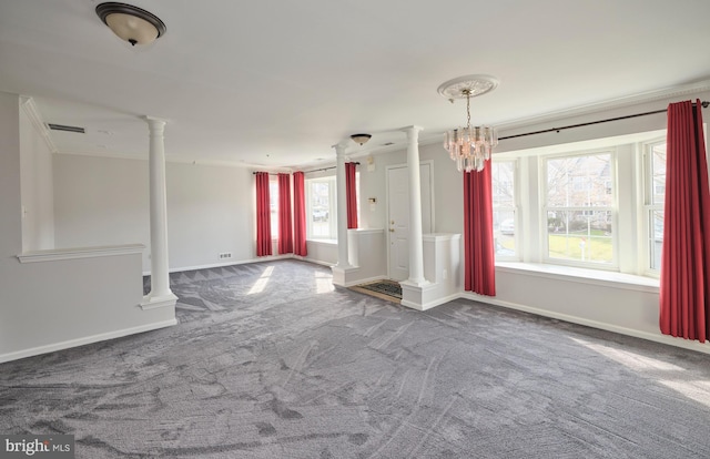 unfurnished room featuring decorative columns, visible vents, baseboards, and carpet floors