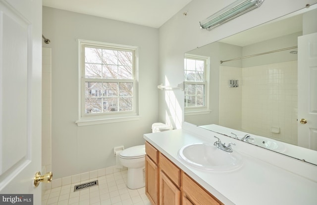 bathroom featuring visible vents, toilet, tile patterned flooring, a shower, and vanity