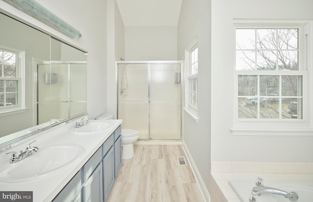 bathroom with a wealth of natural light, toilet, and a sink