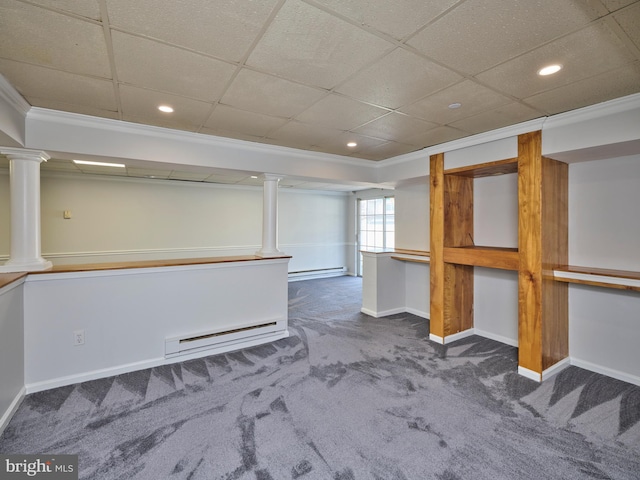 basement featuring baseboard heating, baseboards, and carpet