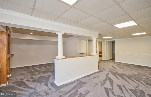 finished basement featuring a drop ceiling, baseboards, and carpet flooring