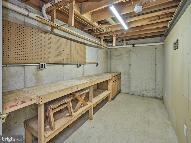 unfinished basement with a workshop area and light floors