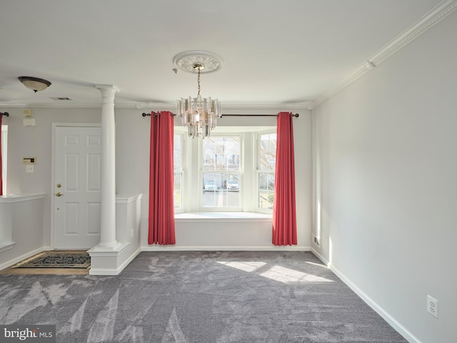 unfurnished dining area featuring baseboards, carpet floors, crown molding, and ornate columns