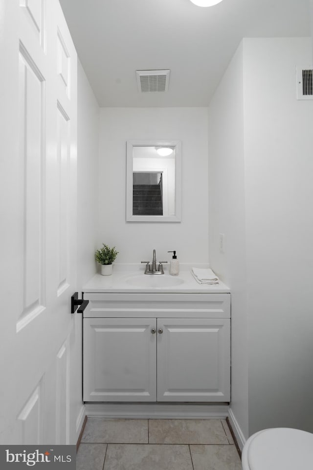 bathroom featuring tile patterned floors, visible vents, toilet, and vanity