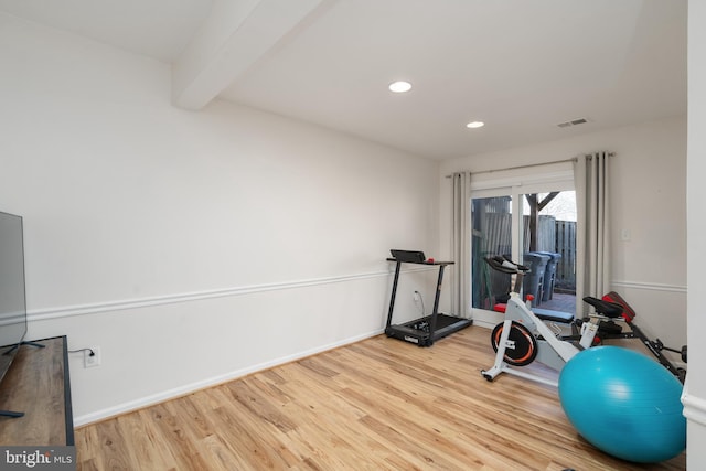 exercise area with recessed lighting, visible vents, baseboards, and wood finished floors