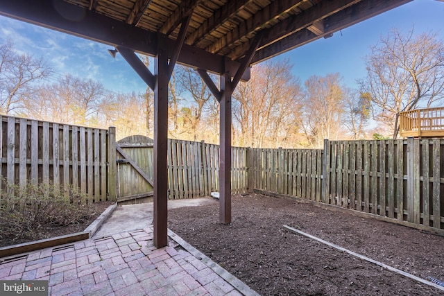 view of yard featuring a patio, a gate, and a fenced backyard