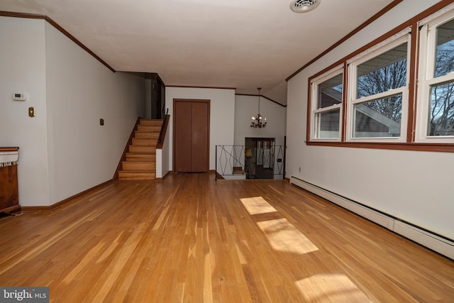 unfurnished living room with light wood finished floors, visible vents, crown molding, and a baseboard radiator