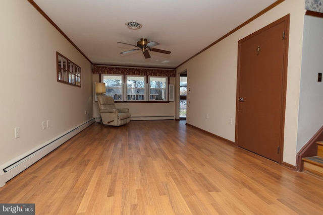 unfurnished room with visible vents, crown molding, a baseboard heating unit, and light wood-style floors