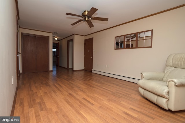 living area with a ceiling fan, a baseboard heating unit, light wood-style floors, crown molding, and baseboards