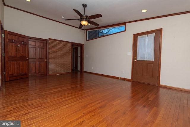 unfurnished room with light wood-type flooring, baseboards, a ceiling fan, and crown molding