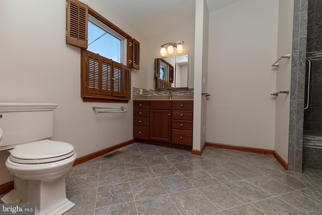 bathroom featuring visible vents, toilet, vanity, and baseboards