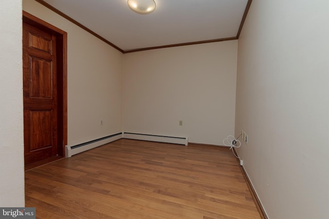 unfurnished room with crown molding, baseboards, light wood-type flooring, and baseboard heating