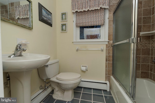 bathroom with tile patterned floors, toilet, bath / shower combo with glass door, and a baseboard radiator