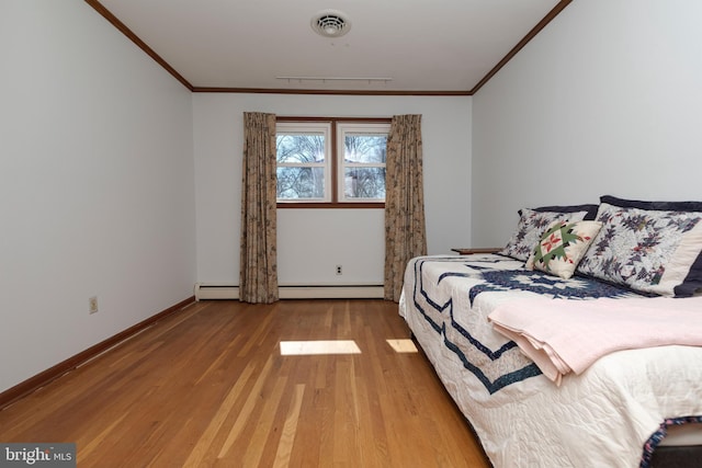 bedroom with a baseboard radiator, wood finished floors, baseboards, and ornamental molding