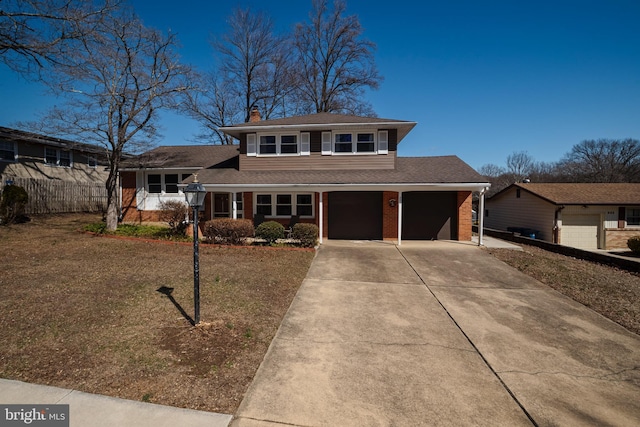 view of front facade with brick siding, driveway, a chimney, and fence