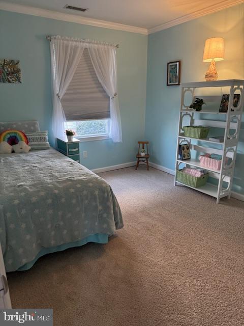 bedroom with visible vents, baseboards, carpet, and ornamental molding