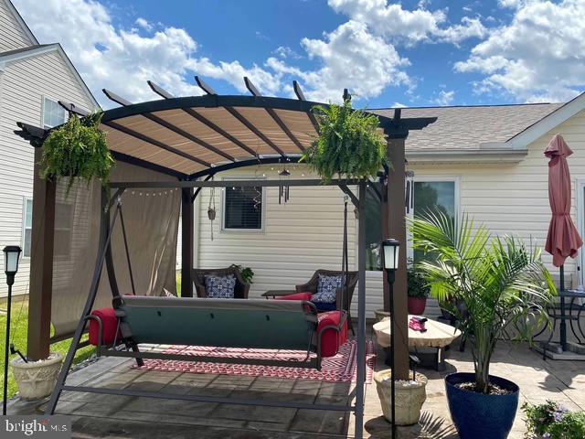 view of patio with outdoor lounge area and a pergola